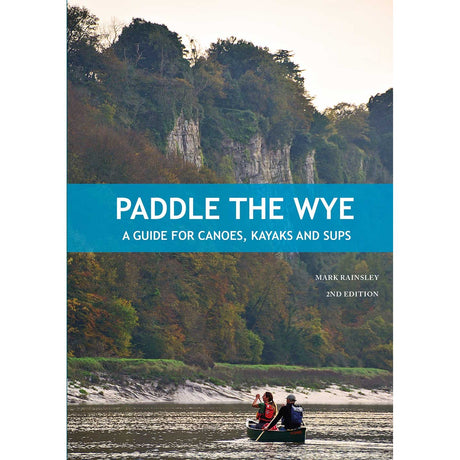 Two people paddle a canoe along the scenic River Wye, gliding past lush trees and dramatic cliffs. Text reads: "Paddle the Wye by Mark Rainsley, 2nd Edition – A comprehensive guide for canoes, kayaks, and paddleboards from Pesda Press.