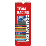 A red, rectangular spiral-bound book titled "Team Racing Companion" by Fernhurst Books, featuring a sailboat photo on the cover, a colorful contents list, and expert advice on sailing teamwork and team racing.