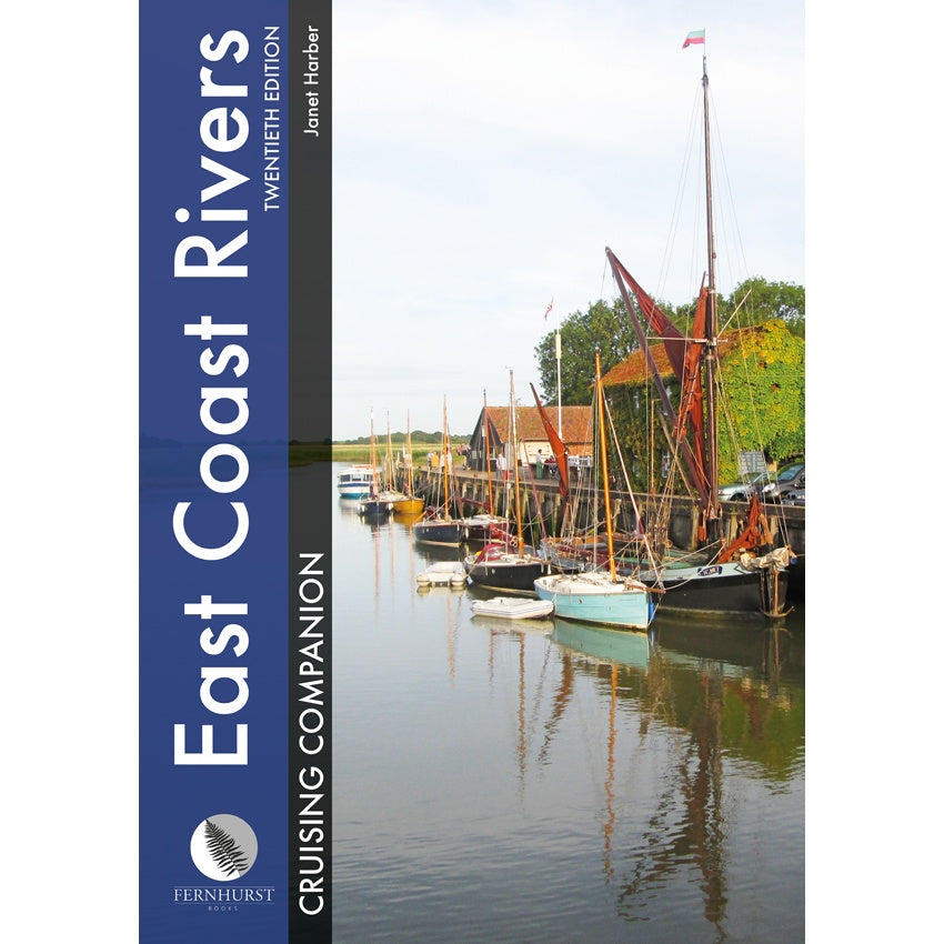 The cover of Fernhurst Books' "East Coast Rivers Cruising Companion" features sailboats on a tranquil river, with trees and red-roofed buildings, and the title is displayed vertically on a blue banner.