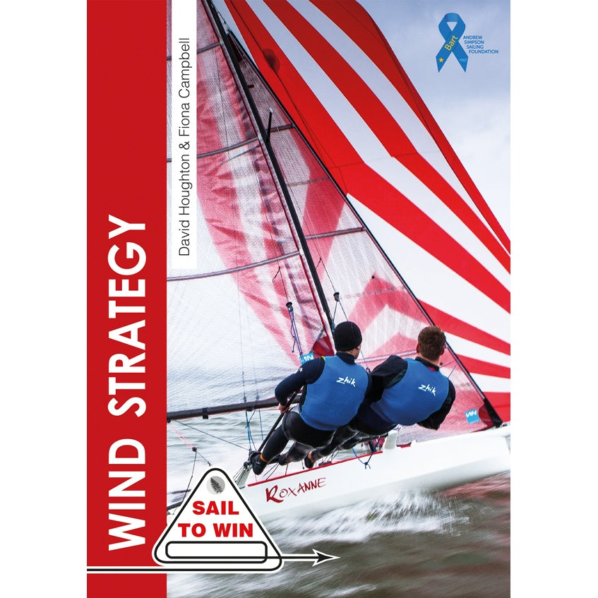 The cover of "Wind Strategy" by Fernhurst Books features two sailors in blue on the sailboat "Roxanne" with red and white sails, against an ocean backdrop. A "Sail to Win" logo appears at the bottom—ideal for dinghy sailing fans.