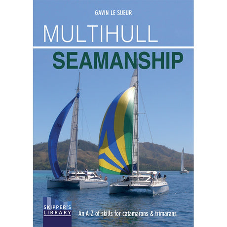 Fernhurst Books’ "Multihull Seamanship" book cover shows two colorful catamarans sailing on blue water with hills behind. Subtitle: “An A-Z of skills for catamaran sailing & trimaran sailing.”.