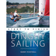 Two people sail a small dinghy with red and white sails. Below, text reads: "Dinghy Sailing: Start to Finish – Fernhurst Books," the ideal guide for learning to sail and mastering dinghy techniques. Sunlight shimmers underwater.