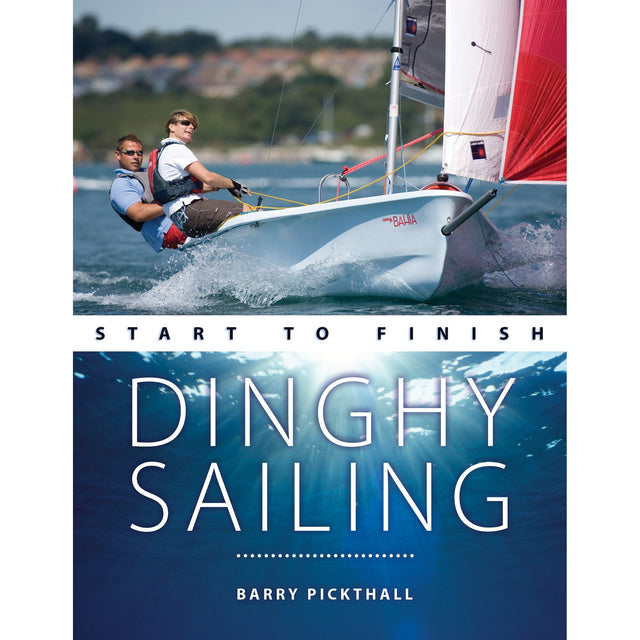 Two people sail a small dinghy with red and white sails. Below, text reads: "Dinghy Sailing: Start to Finish – Fernhurst Books," the ideal guide for learning to sail and mastering dinghy techniques. Sunlight shimmers underwater.
