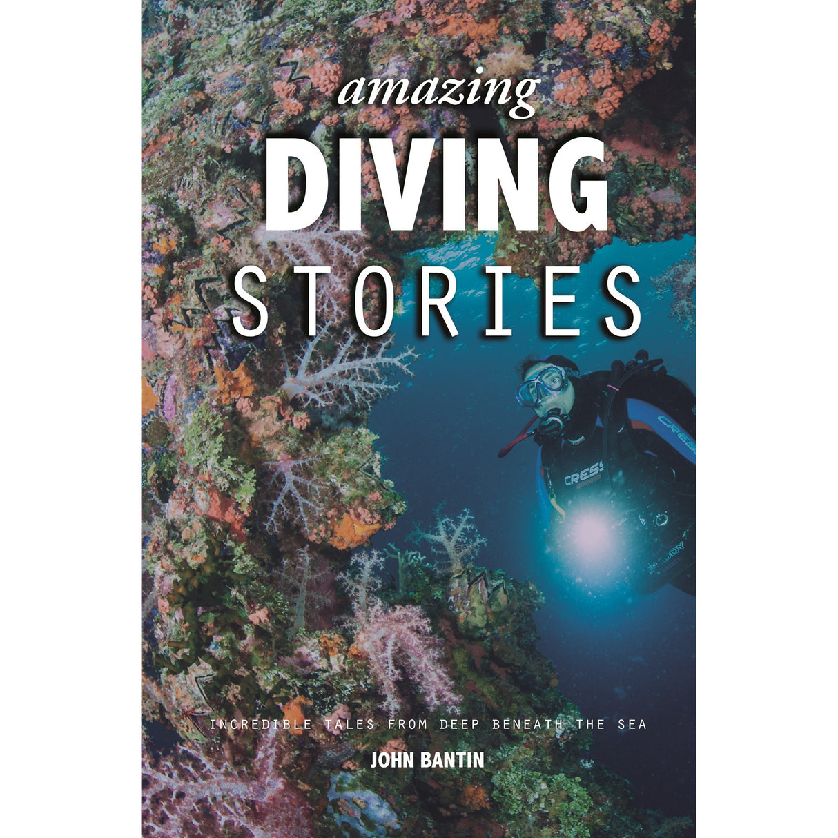 A scuba diver explores a vivid coral reef surrounded by clear blue water on the cover of "Amazing Diving Stories" by Fernhurst Books. Ideal for diving enthusiasts.