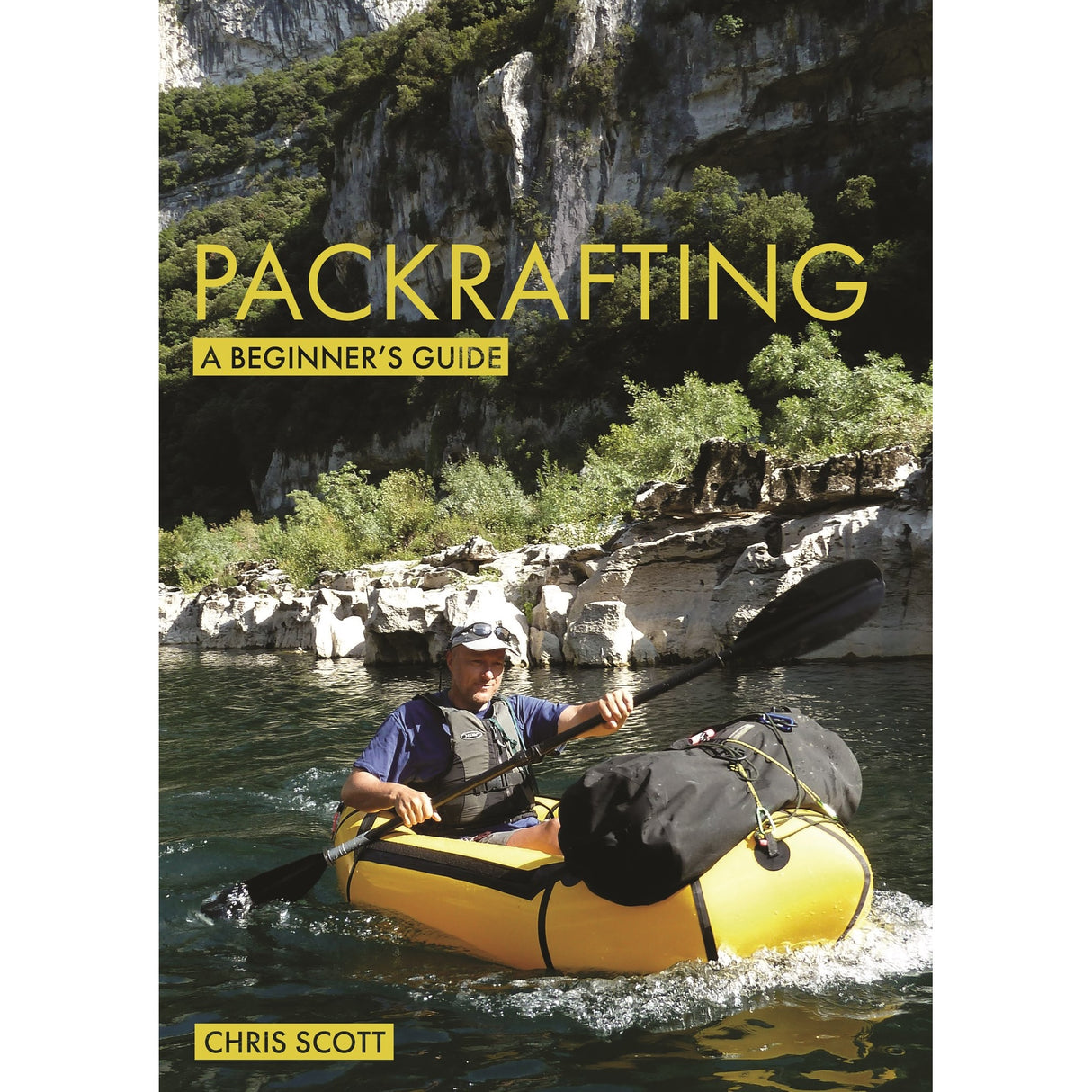 A person paddles a yellow packraft along a river with rocky cliffs and greenery. "Packrafting: A Beginner's Guide" by Fernhurst Books is shown in bold yellow text—ideal for beginners interested in packrafting.