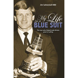 A man in a suit holds a large sailing trophy. The book cover reads: "My Life In A Blue Suit" by Fernhurst Books, telling the story of Olympic sailing coach Jim Saltonstall MBE, who helped make Britain great at sailing.