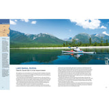 Wearing a red life jacket, a kayaker paddles across calm Lake Baikal in Russia, surrounded by mountains and forests. Info text appears on the left and bottom. Book: Ultimate Paddling Adventures by Fernhurst Books.