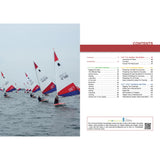 A row of small sailboats with red, white, and blue sails race on calm water under a gray sky; on the right is the Topper Book by Fernhurst Books, open to its contents page about sailing, boat handling, and racing tactics.