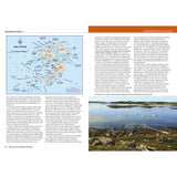 On the left is a map of the Isles of Scilly and info about the area; on the right, inspired by Fernhurst Books' West Country Cruising Companion, are small boats in a calm bay with a rocky shore and grassy land beneath a clear sky.