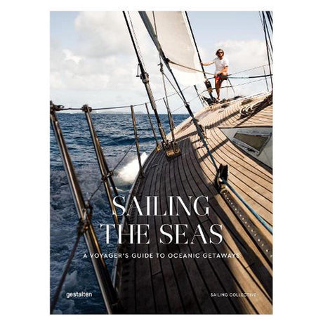 The cover of "Sailing the Seas" by gestalten showcases a sailor steering a sailboat on the ocean, capturing nautical adventures. A wooden deck curves in the foreground with billowing sails and a clear sky, along with the text: "A Voyager's Guide to Oceanic Getaways.