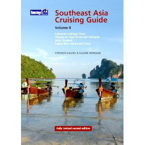 The cover of Imray’s "Southeast Asia Cruising Guide – Volume II" shows traditional wooden boats in clear waters, limestone cliffs, and lush greenery. Authors: Stephen Davies and Elaine Morgan.