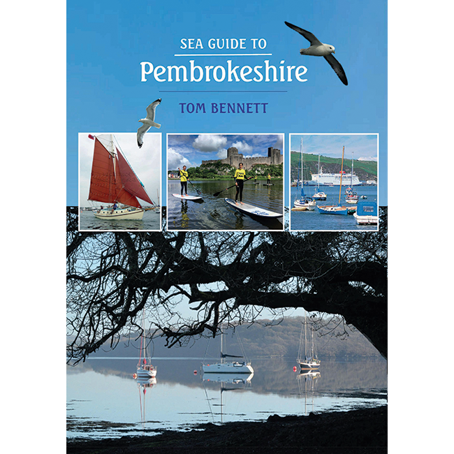 Cover of the book "Sea Guide to Pembrokeshire" by Imray. It features images of a sailing boat, paddleboarders near a castle, and moored sailboats. Above, a seagull soars in a clear blue sky. The bottom image shows a serene lake with reflections of boats and a tree—a perfect guide for the outdoor water enthusiast.