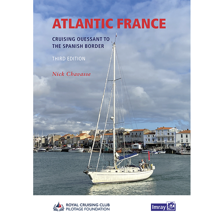 A white sailboat floats in a calm harbor, lined with red-roofed houses under a blue sky. The book title "Atlantic France" by Imray is overlaid, showcasing this essential cruising guide for exploring the Atlantic coast.