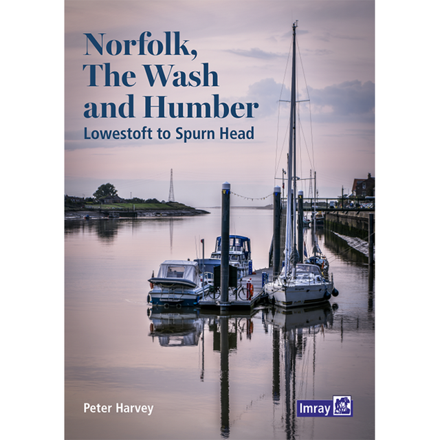 The cover of Imray's book, "Norfolk, The Wash and Humber," showcases a tranquil marina at dusk on the east coast of England, with several moored boats. The sky and water are tinged with soft purple hues, reflecting the calm ambiance of the scene.