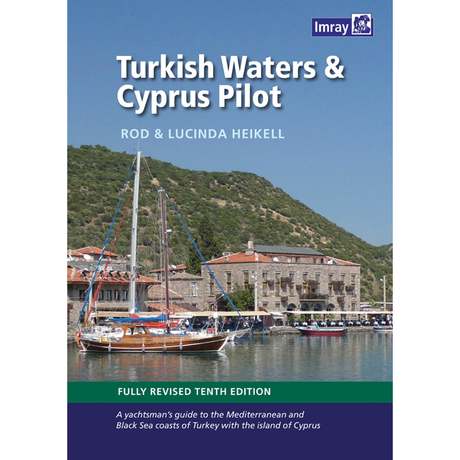 Cover of the book "Turkish Waters & Cyprus Pilot" by Rod and Lucinda Heikell. The image displays a docked yacht in front of a picturesque Mediterranean coastal village with green hills in the background, evoking the charm of Göçek. The cover highlights that it's the fully revised tenth edition, published by Imray.