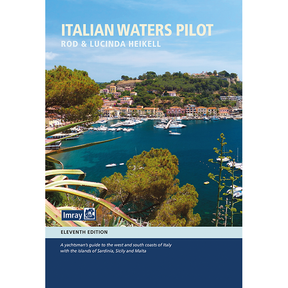 Cover of the 11th edition of Imray's "Italian Waters Pilot" by Rod and Lucinda Heikell, showcasing a coastal village with colorful buildings, docked boats in a marina, and lush greenery—a vital guide for Mediterranean sailing around Italy and nearby islands.