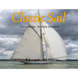 A white sailboat with tall sails drifts on calm water beneath clouds. Text: "Classic Sail 2026 Calendar · Kathy Mansfield." Ideal for classic sailboat enthusiasts and nautical photography fans.