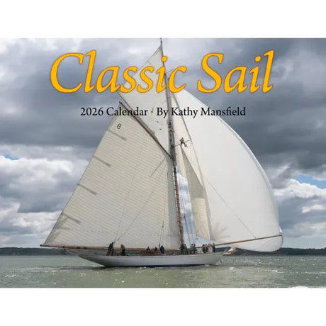A white sailboat with tall sails drifts on calm water beneath clouds. Text: "Classic Sail 2026 Calendar · Kathy Mansfield." Ideal for classic sailboat enthusiasts and nautical photography fans.