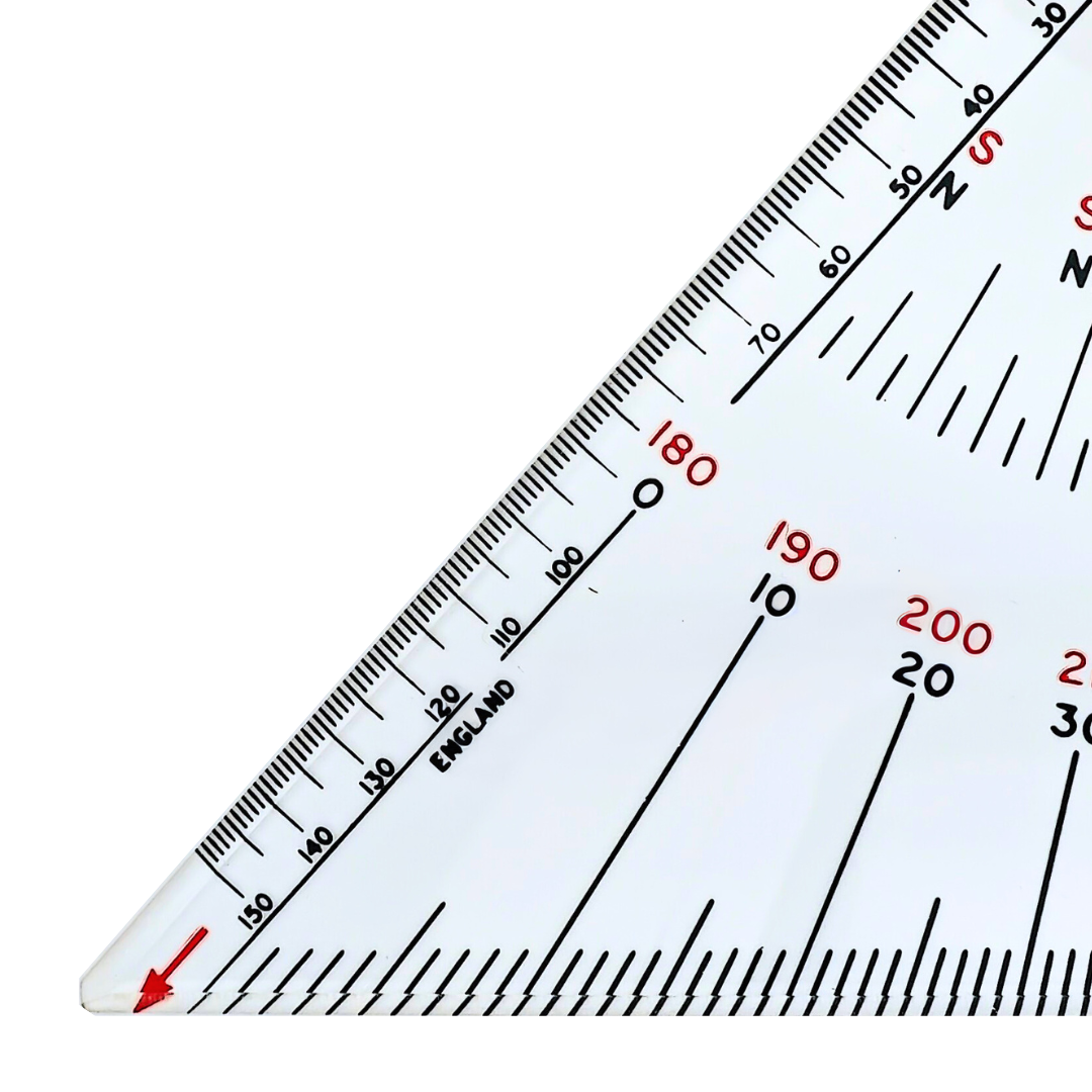 Close-up of a clear 12" Navigation Triangle by Charles, Smith & Reddish, marked with various measurement scales and numbers, reminiscent of a tool used in nautical charts. The scales are labeled in increments, and the word "England" is visible on one side. The triangle features a red arrow near the base.