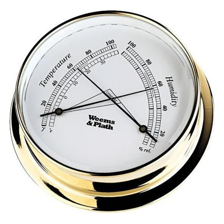 The Weems & Plath Brass Endurance 125 Comfortmeter features a white face that displays temperature measurements in both Celsius and Fahrenheit, as well as humidity percentages. Its refined needles indicate approximately 70°F and 45% relative humidity, offering accurate information about room conditions.