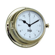 The Weems & Plath Brass Endurance II 135 Quartz Clock features a white face with Arabic numerals for 12-hour and 24-hour formats, black hour, minute, and second hands, and weather-resistant construction. The brand name is printed on the clock face in this nautical-style timepiece.