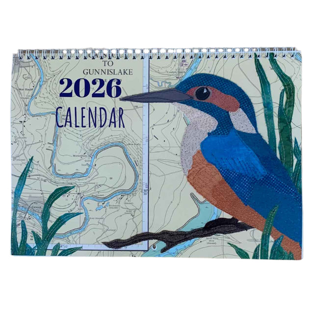 The Hannah Wisdom Coastal Calendar 2026 by Hannah Wisdom Textiles features a map-themed cover with an illustrated kingfisher among green reeds, inspired by textile art, and "To Gunnislake 2026 Calendar" at the top.