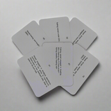 A scattered arrangement of six "Flip Cards - Lights and Shapes" from the Flip Cards brand, featuring text printed on them. The cards are spread in a circular pattern with partial overlap, resembling navigation lights, making the content only partially legible against a plain, light background.