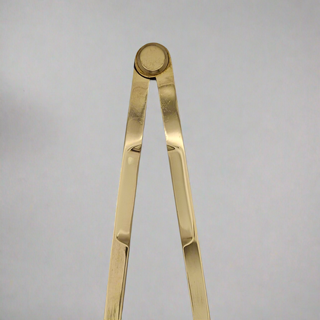 A close-up image of the Chartwright 7" Straight Brass Dividers, a precision instrument used for drawing circles or measuring distances, opened at an angle against a plain light gray background.