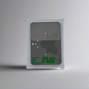 The "Flip Cards - Lights and Shapes" card deck by Flip Cards comes in a semi-transparent white plastic sleeve. The front of each card showcases minimalist designs with green and red dots reminiscent of navigation lights, paired with abstract shapes set against a grey background.