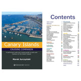 Cover of "Canary Islands Cruising Companion" from Fernhurst Books by Marek Jurczyński, depicting a lively marina. The contents provide nautical details on various Canary Islands ports like Gran Canaria and Tenerife, making it an essential guide for sailors.