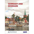 The cover of the book titled "Germany & Denmark" by Nicholas Hill features a tranquil waterfront scene with boats, vibrant buildings, and a green spire in the background, capturing the picturesque charm of the German Baltic coast. Published by Imray and the Royal Cruising Club Pilotage Foundation, it is presented as a first edition.