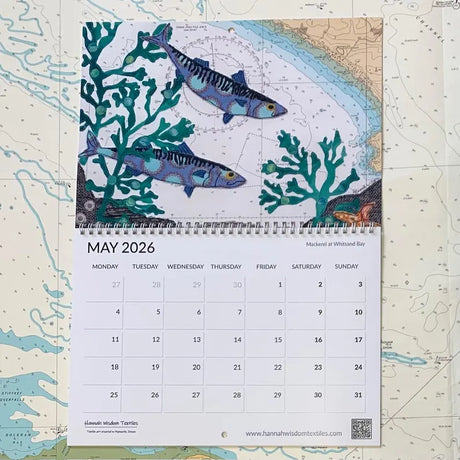 A May 2026 page from the Hannah Wisdom Coastal Calendar 2026 by Hannah Wisdom Textiles, featuring "Mackerel at Whistand Bay"—an illustrated fish and seaweed scene above a nautical map.