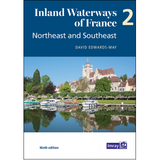 The image shows the cover of a book titled "Inland Waterways of France | Volume 2 | Northeast and Southeast" by Imray. The cover features a scenic photo of boats docked along a navigable river with charming buildings and a church in the background, emphasizing this beautiful boating destination.