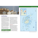 The North Brittany & Channel Islands Cruising Companion by Fernhurst Books features a nautical map of Les Écréhous, showing sailboats near rocky islets with small buildings, accompanied by informative text on the left and a detailed pilotage map on the right for Channel Islands navigation.