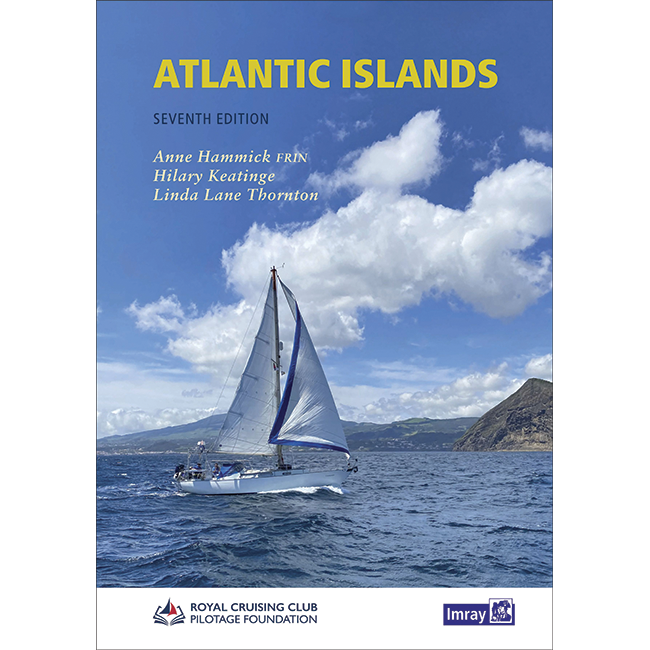 The cover of the Imray guide "Atlantic Islands: Seventh Edition" by Anne Hammick FRIN, Hilary Keatinge, and Linda Lane Thornton depicts a sailboat navigating blue waters with a mountainous island in the background under a clear sky. The Royal Cruising Club Pilotage Foundation's logo is displayed at the bottom.