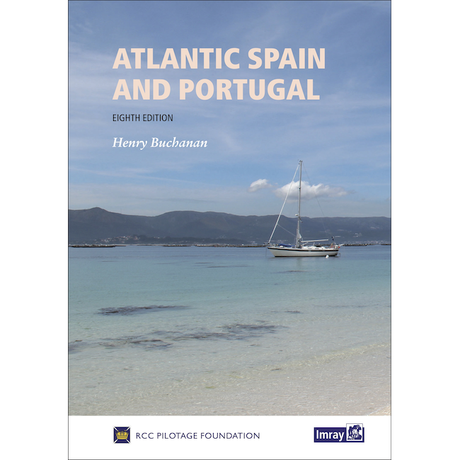 The cover of "Atlantic Spain & Portugal" (Eighth Edition) by Henry Buchanan, an indispensable navigational guide, features a sailboat anchored in clear blue waters under a partly cloudy sky with distant mountains in the background. The book is published by Imray and the RCC Pilotage Foundation.