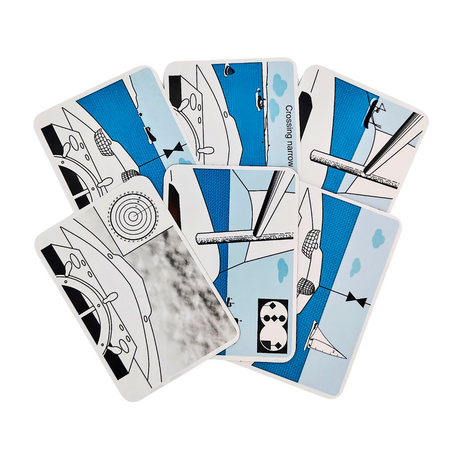 Six "Flip Cards: Rule of the Road" by Flip Cards are spread out, each showcasing abstract illustrations in black, white, and blue. The designs incorporate geometric shapes and patterns reminiscent of mechanical themes related to traffic scenarios. The cards are face-up and have a slight overlap.