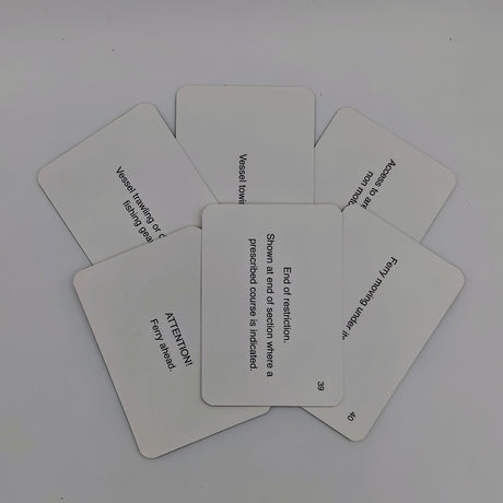 A fan of five white cards displayed on a plain surface. Each card features black text with instructions or phrases. The center card reads, "End of restriction," and shows the direction where a prescribed course is indicated—perfect for preparing for an RYA examination or obtaining your CEVNI endorsement.