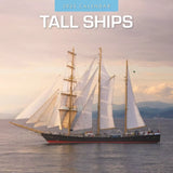 The Red Robin Tall Ships 2025 Calendar by Red Robin Publishing features a majestic tall ship with large sails gliding across the calm sea beneath a cloudy sky, perfect for any sailing enthusiast with hills in the background.