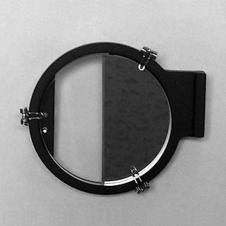 A SailorShop black circular wall mirror with a hinge attachment echoes the precision of the Celestaire Astra IIIB Deluxe Sextant, half reflecting a textured surface. Much like celestial navigation, it forms two distinct sections: one illuminated and the other in shadow, expertly directing your gaze across its face.