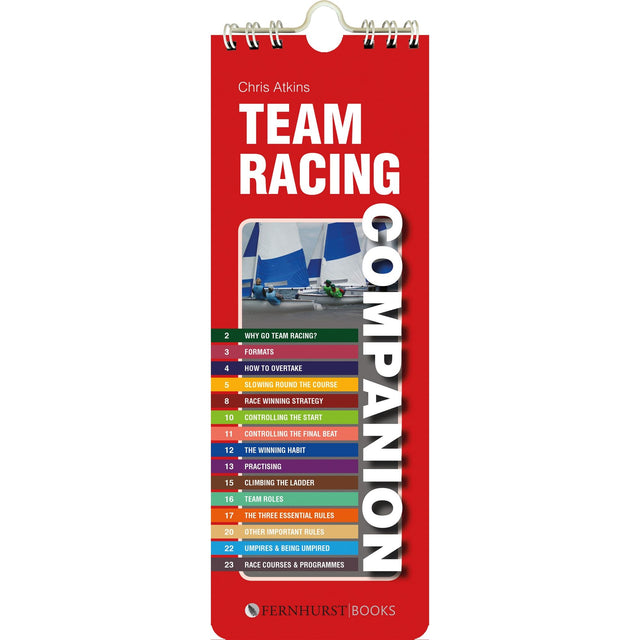 The image displays the cover of "Team Racing Companion" by Fernhurst Books, authored by Chris Atkins, focusing on race control and improvement tips with sailing strategies and team racing tactics set against a sailboat backdrop.