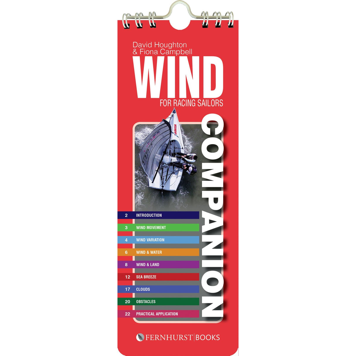 The "Wind Companion" by David Houghton and Fiona Campbell features a vibrant red cover with a sailboat image and offers chapters on wind patterns, variation, and sea breezes—key strategies for sailing success. Published by Fernhurst Books.